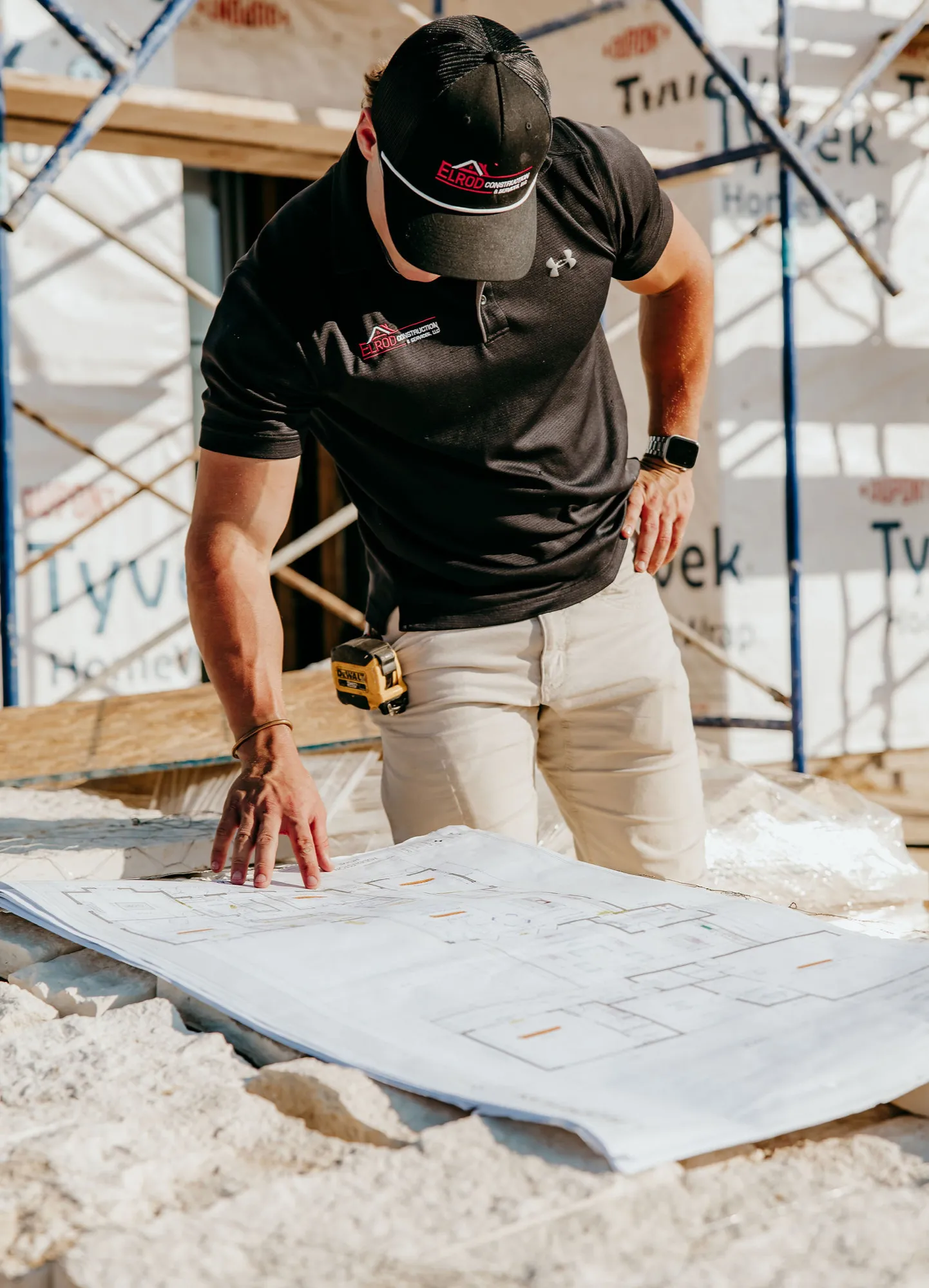 Reese reviewing blueprints on a job site